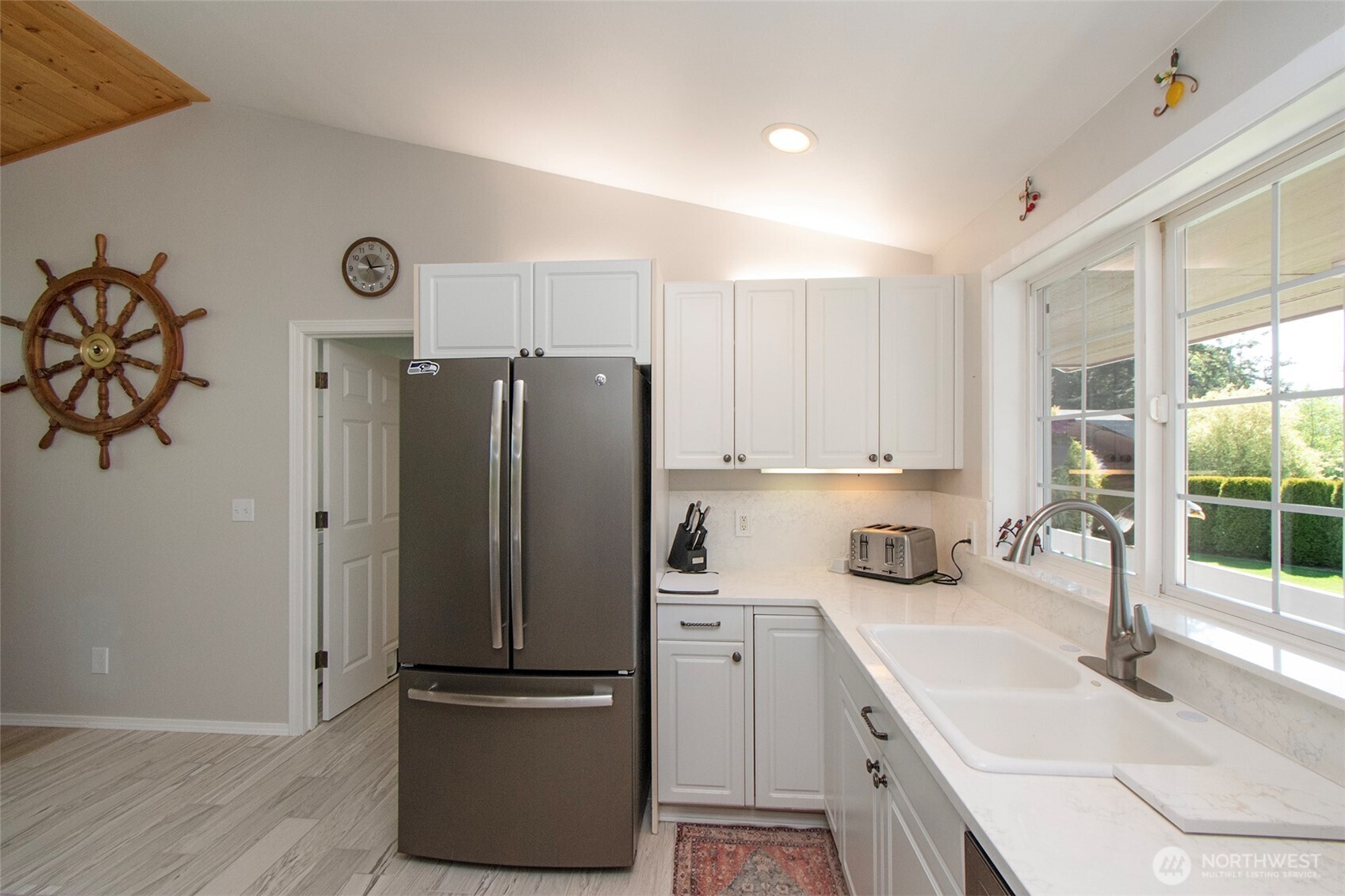 23 Pearl Place Sequim, WA 98382 - Photo 13 of 40 a kitchen with a refrigerator and a sink