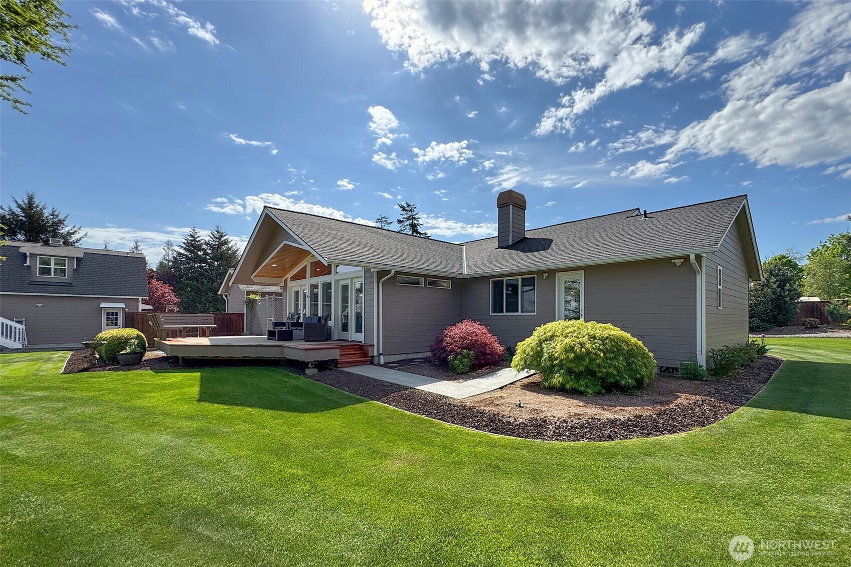 23 Pearl Place Sequim, WA 98382 - Photo 27 of 40 a view of a house with a backyard and sitting area
