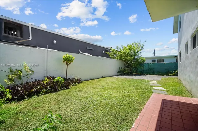 a view of a backyard with potted plants