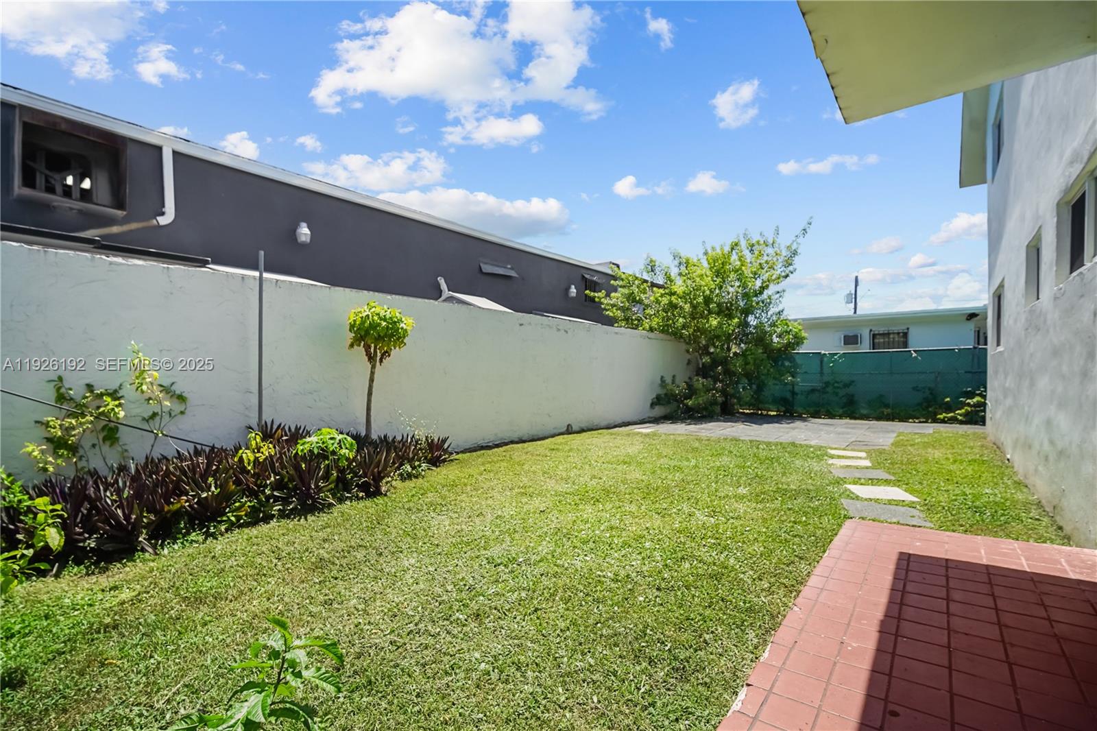 2622 Northwest 24th Street, Unit 3 Miami, FL 33142 - Photo 14 of 21 a view of a backyard with potted plants