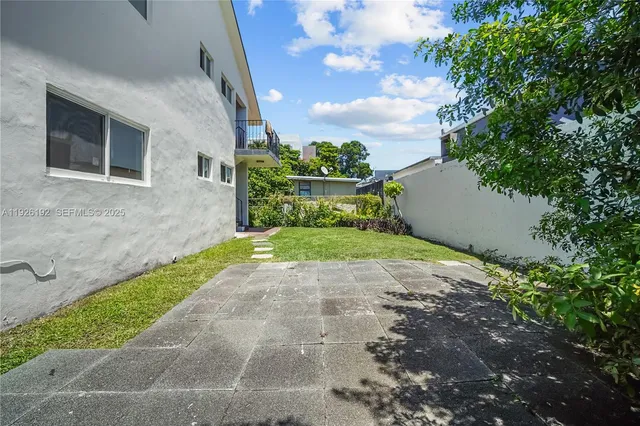 a view of a yard with potted plants