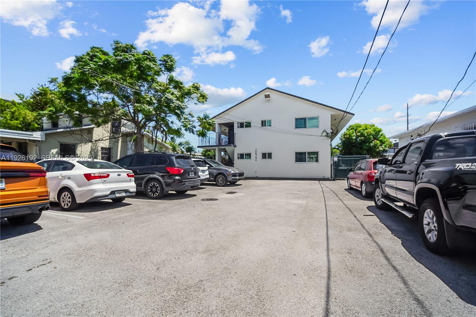 2622 Northwest 24th Street, Unit 3 Miami, FL 33142 - Photo 19 of 21 a view of cars parked in front of a house