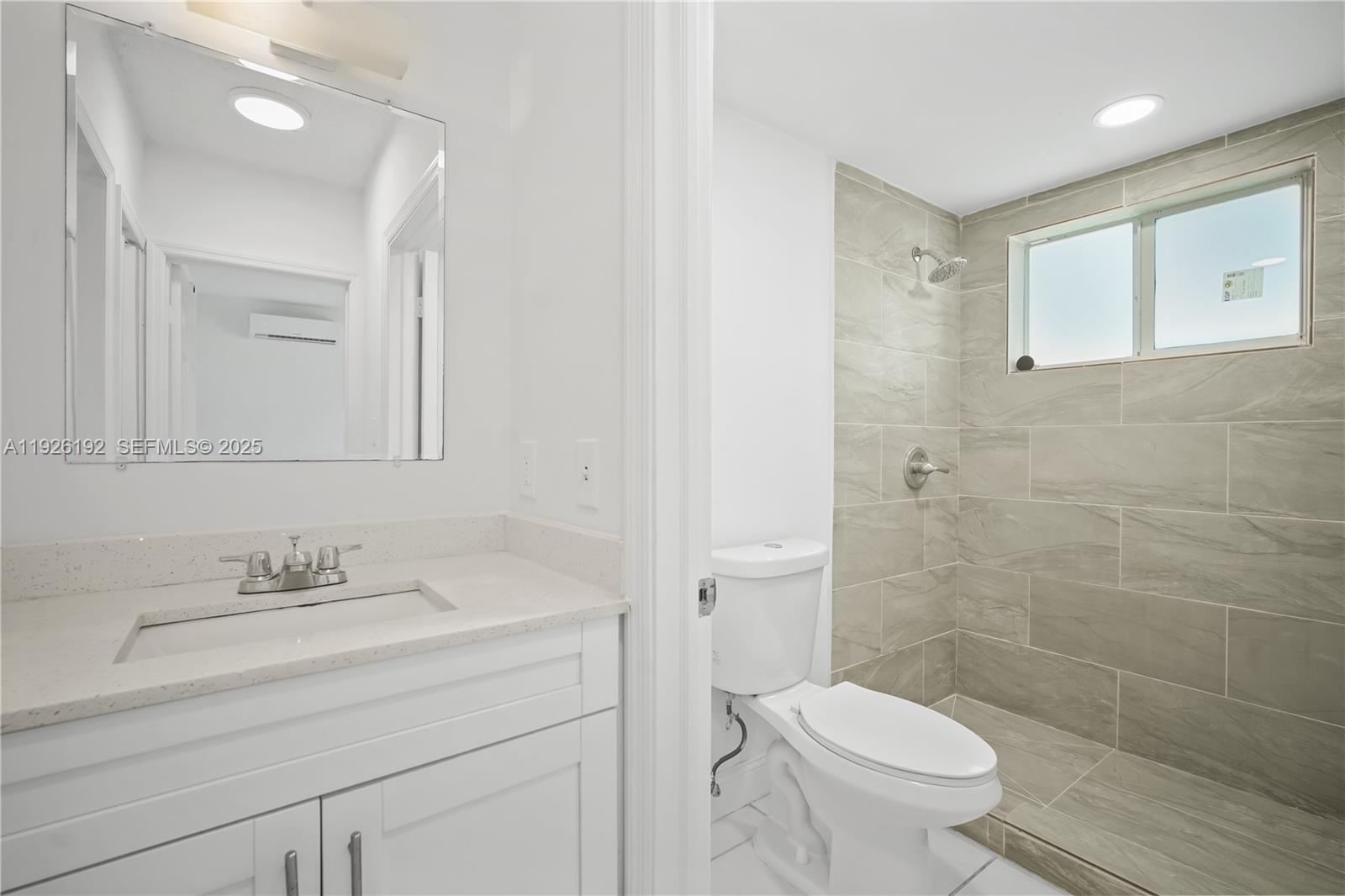 2622 Northwest 24th Street, Unit 3 Miami, FL 33142 - Photo 4 of 21 a bathroom with a sink a toilet and shower