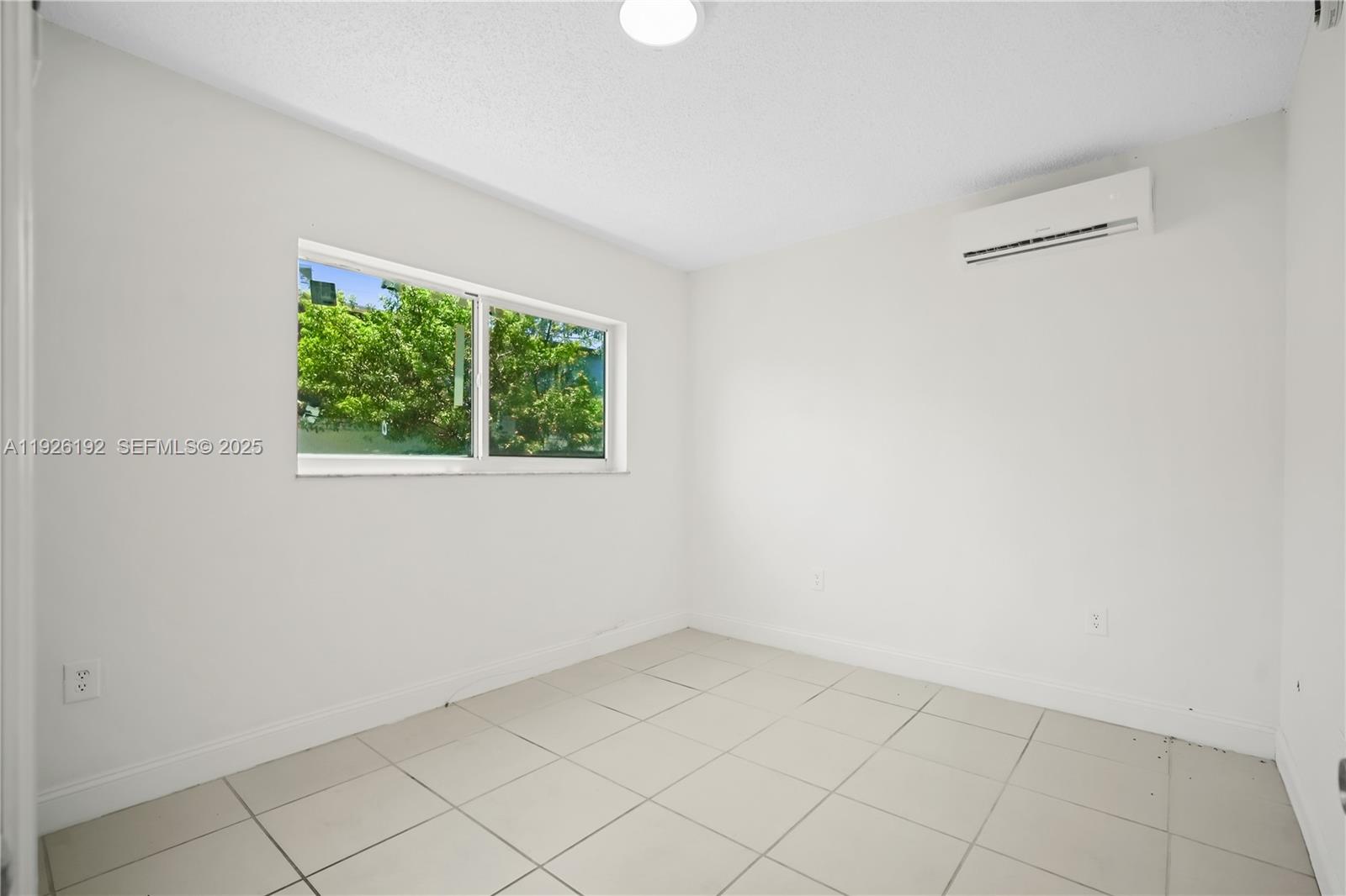 2622 Northwest 24th Street, Unit 3 Miami, FL 33142 - Photo 5 of 21 an empty room with a window
