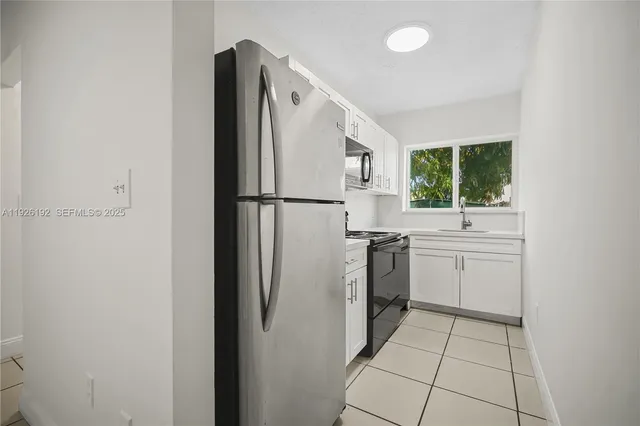 a white refrigerator freezer sitting inside of a kitchen