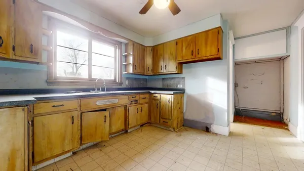 a kitchen with granite countertop a refrigerator and a sink