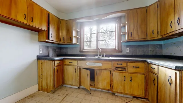 a kitchen with stainless steel appliances granite countertop a sink and cabinets