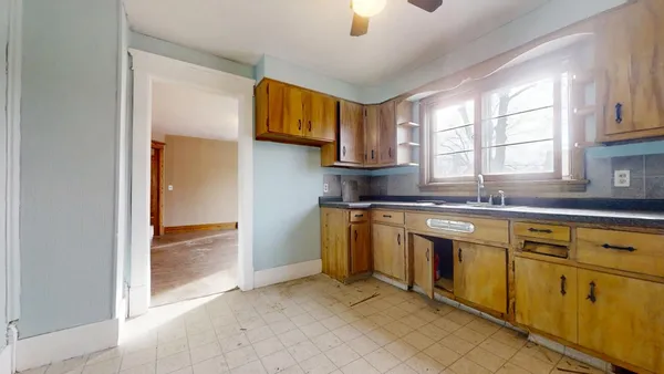 a kitchen with stainless steel appliances granite countertop a sink and a window
