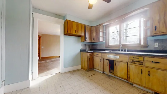 a kitchen with stainless steel appliances granite countertop a sink and a window