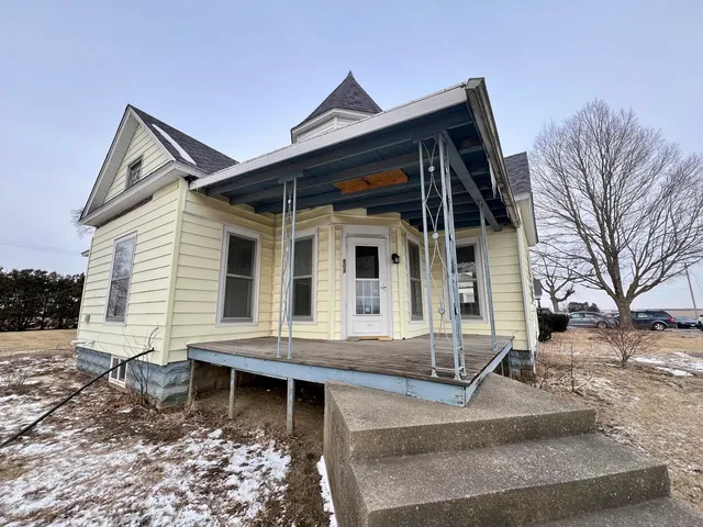 a view of house with a window and wooden fence