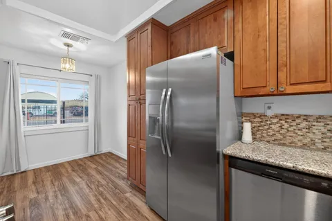 a kitchen with metallic refrigerator and cabinet