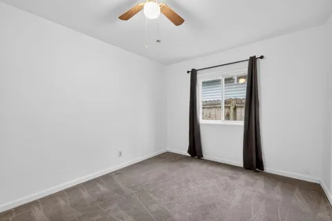 an empty room with a empty space and windows