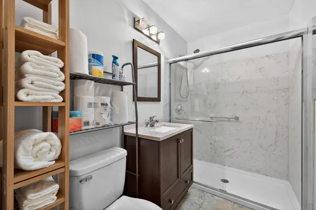 a bathroom with a sink toilet and shower