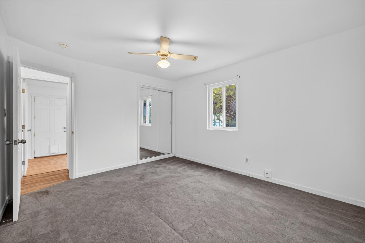 2812 Plover Street Sacramento, CA 95815 - Photo 22 of 40 an empty room with chandelier fan and windows