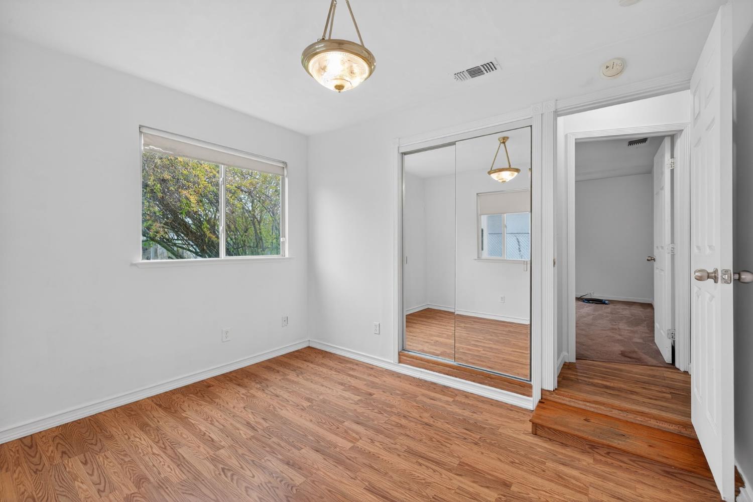 2812 Plover Street Sacramento, CA 95815 - Photo 25 of 40 a view of empty room with wooden floor and fan