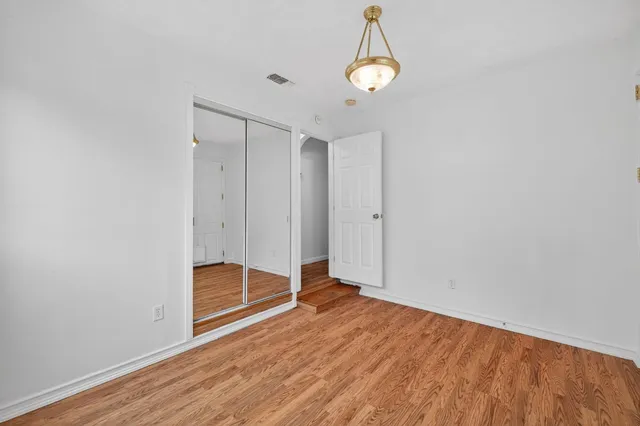 a view of room with wooden floor