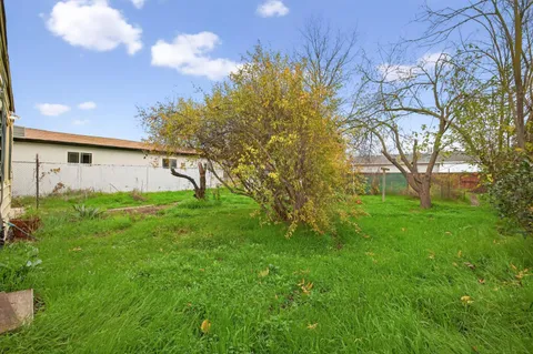 a house view with swimming pool and garden