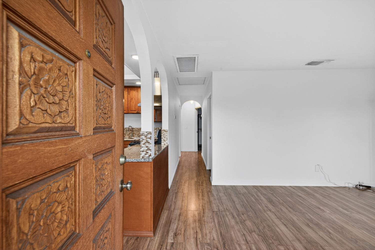 2812 Plover Street Sacramento, CA 95815 - Photo 4 of 40 a view of a hallway with wooden floor and staircase