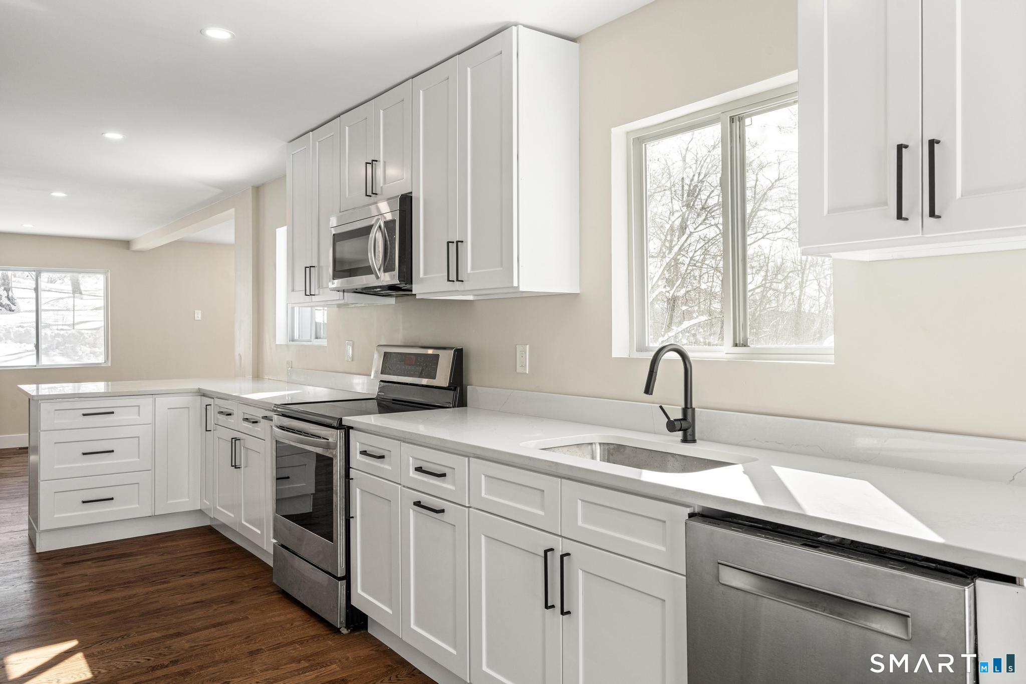 6 Juniper Ridge Drive Danbury, CT 06811 - Photo 14 of 36 a kitchen with white cabinets appliances and a window