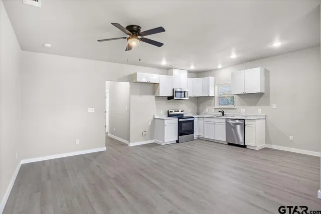 a kitchen with stainless steel appliances a refrigerator and a sink