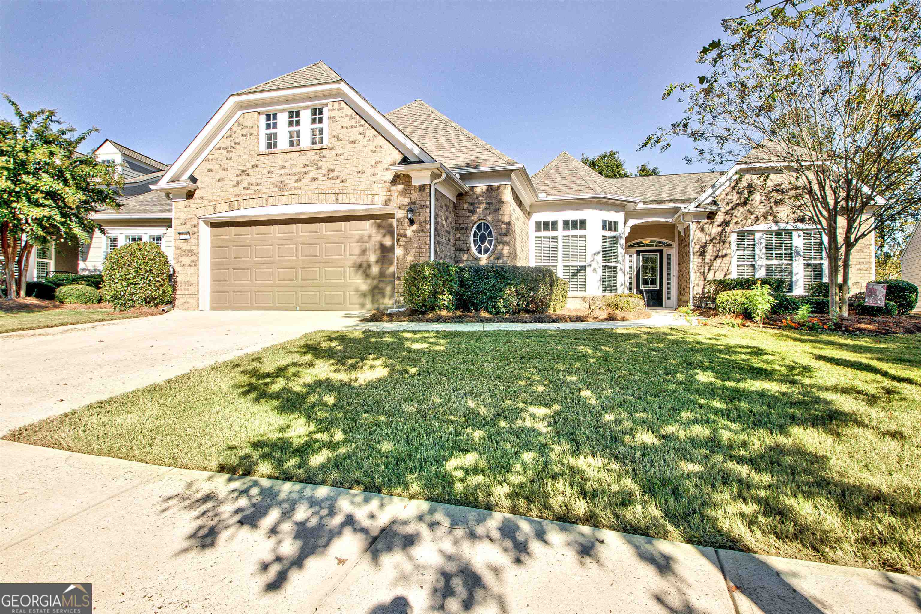 a view of a big building with a big yard and large trees
