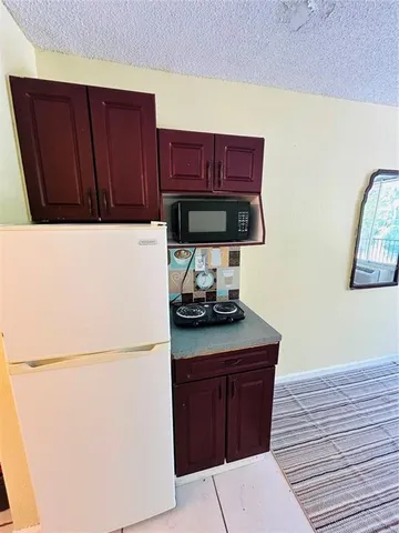 a kitchen with a refrigerator and a cabinets