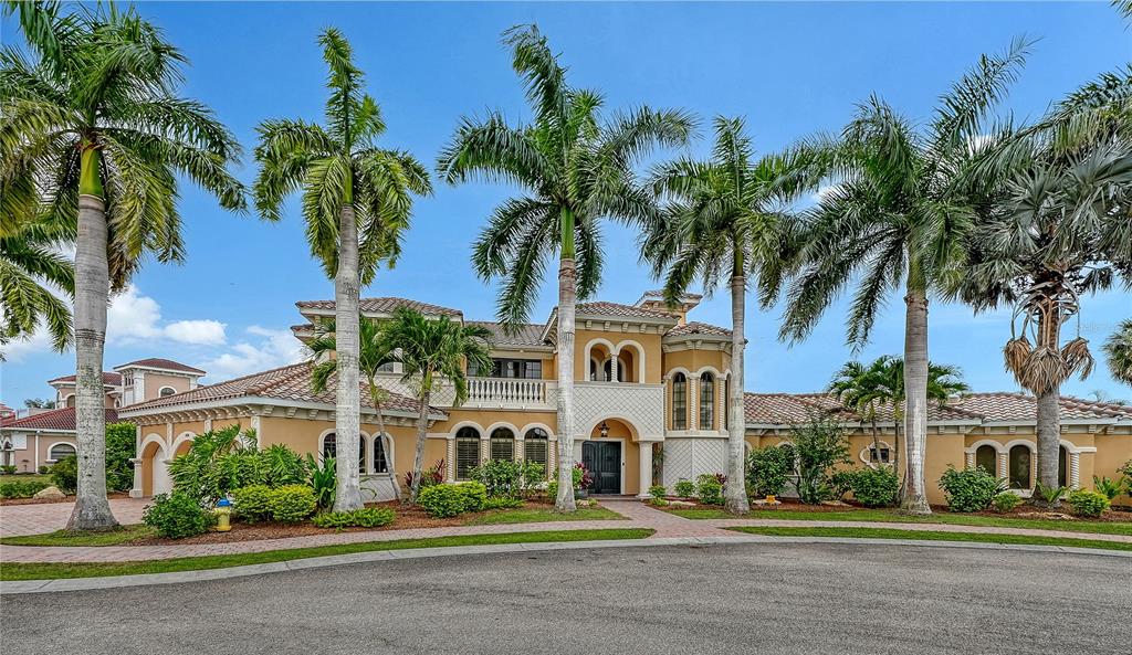 1630 Assisi Drive, Unit 18 Sarasota, FL 34231 - Photo 1 of 42 a front view of multiple houses with yard