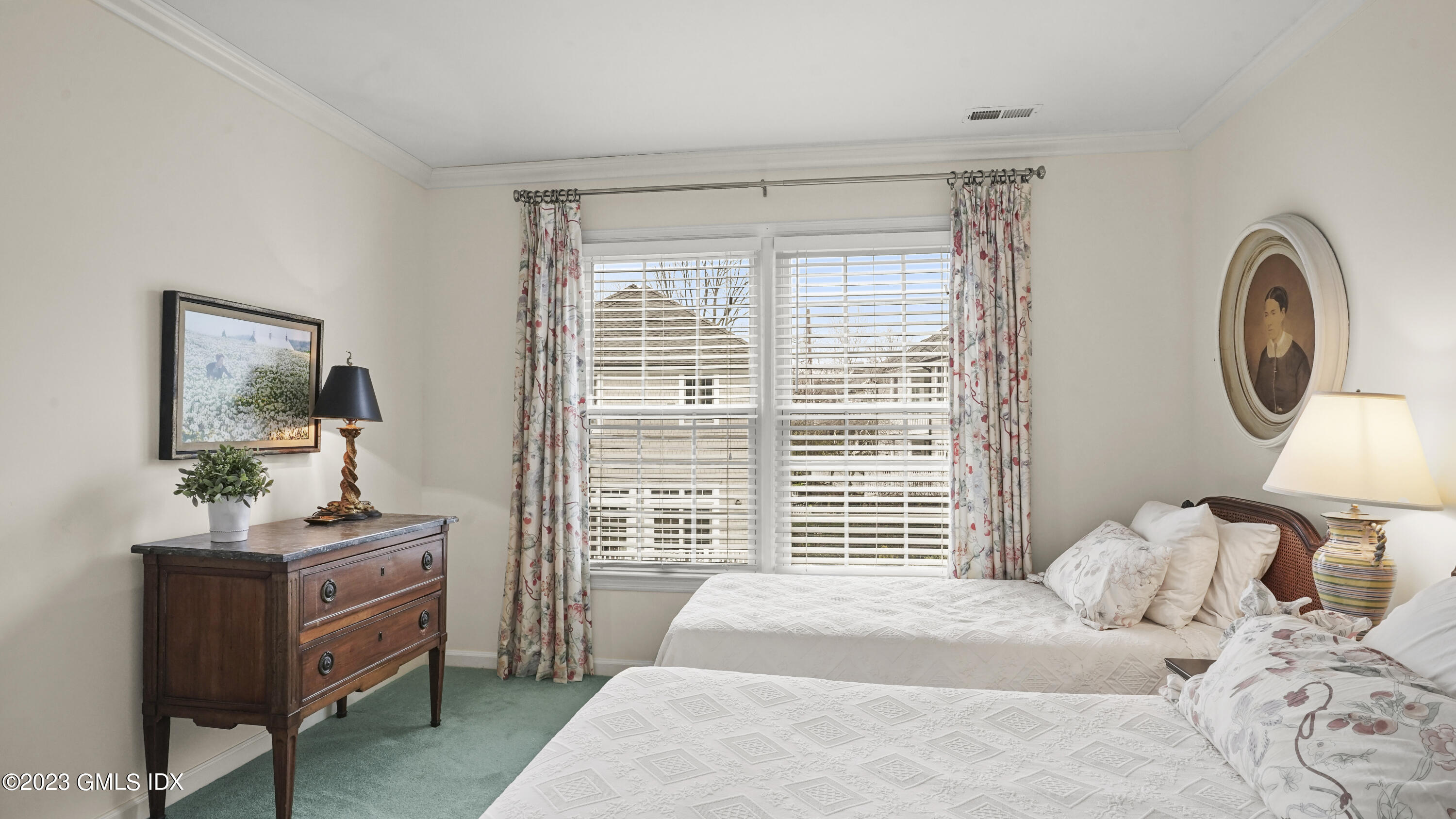172 Field Point Road, Unit 2 Greenwich, CT 06830 - Photo 11 of 17 a bedroom with a bed and a chandelier