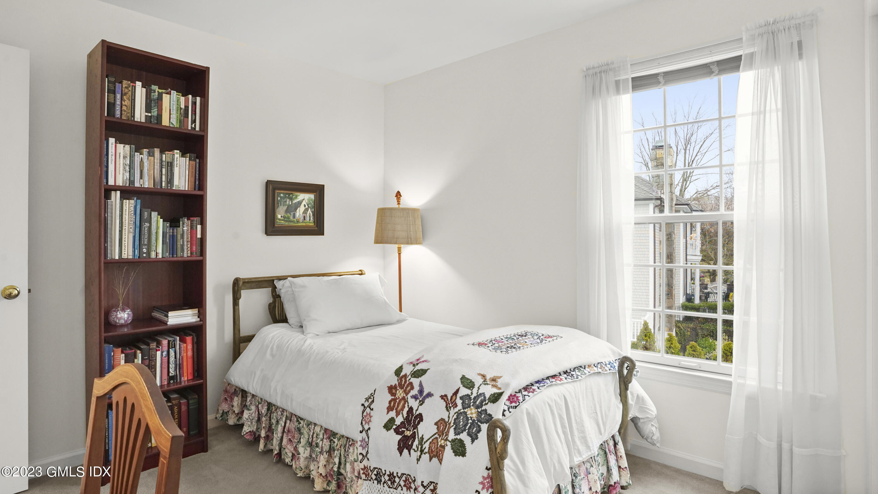 172 Field Point Road, Unit 2 Greenwich, CT 06830 - Photo 12 of 17 a bedroom with a bed a book shelf and a window