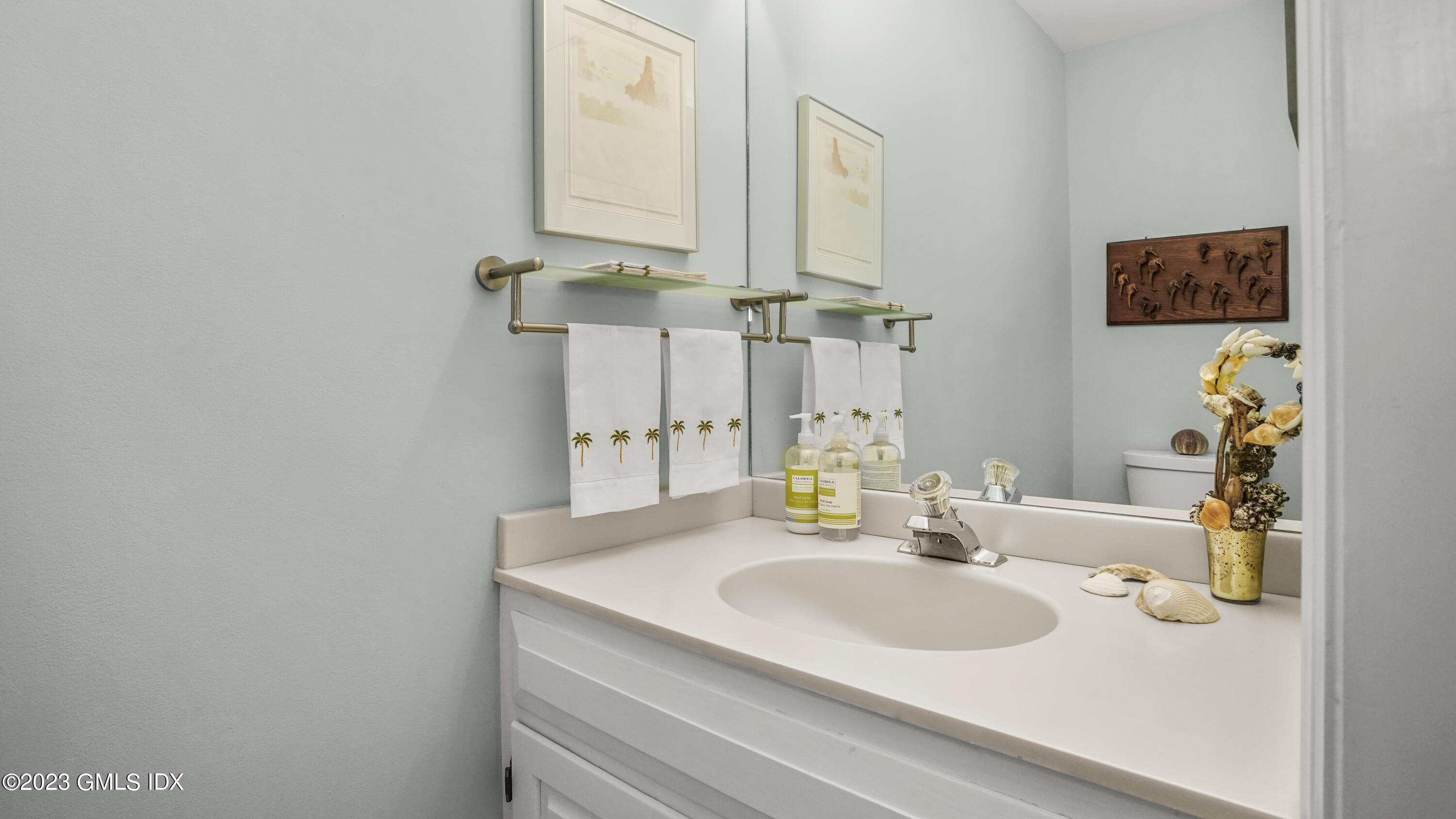 172 Field Point Road, Unit 2 Greenwich, CT 06830 - Photo 15 of 17 a bathroom with a sink and a mirror