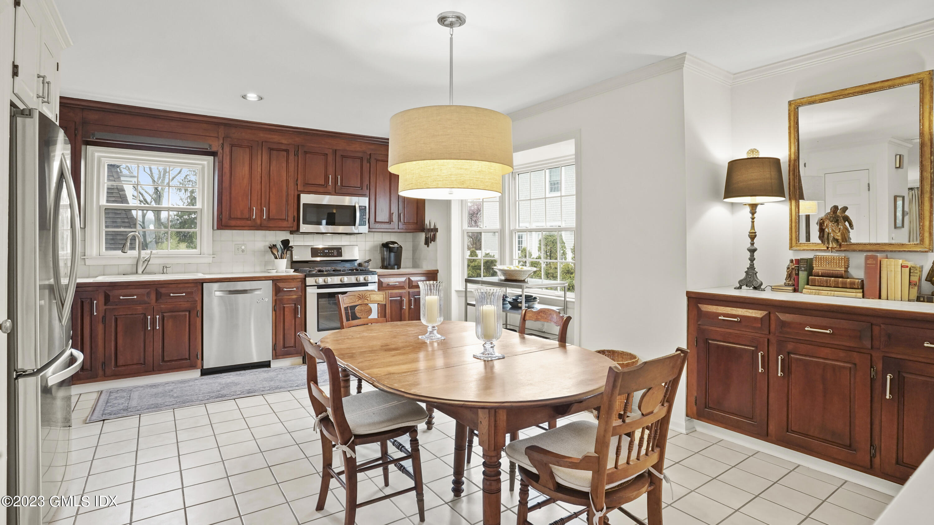 172 Field Point Road, Unit 2 Greenwich, CT 06830 - Photo 8 of 17 a kitchen with stainless steel appliances granite countertop a stove a sink a microwave a dining table and chairs
