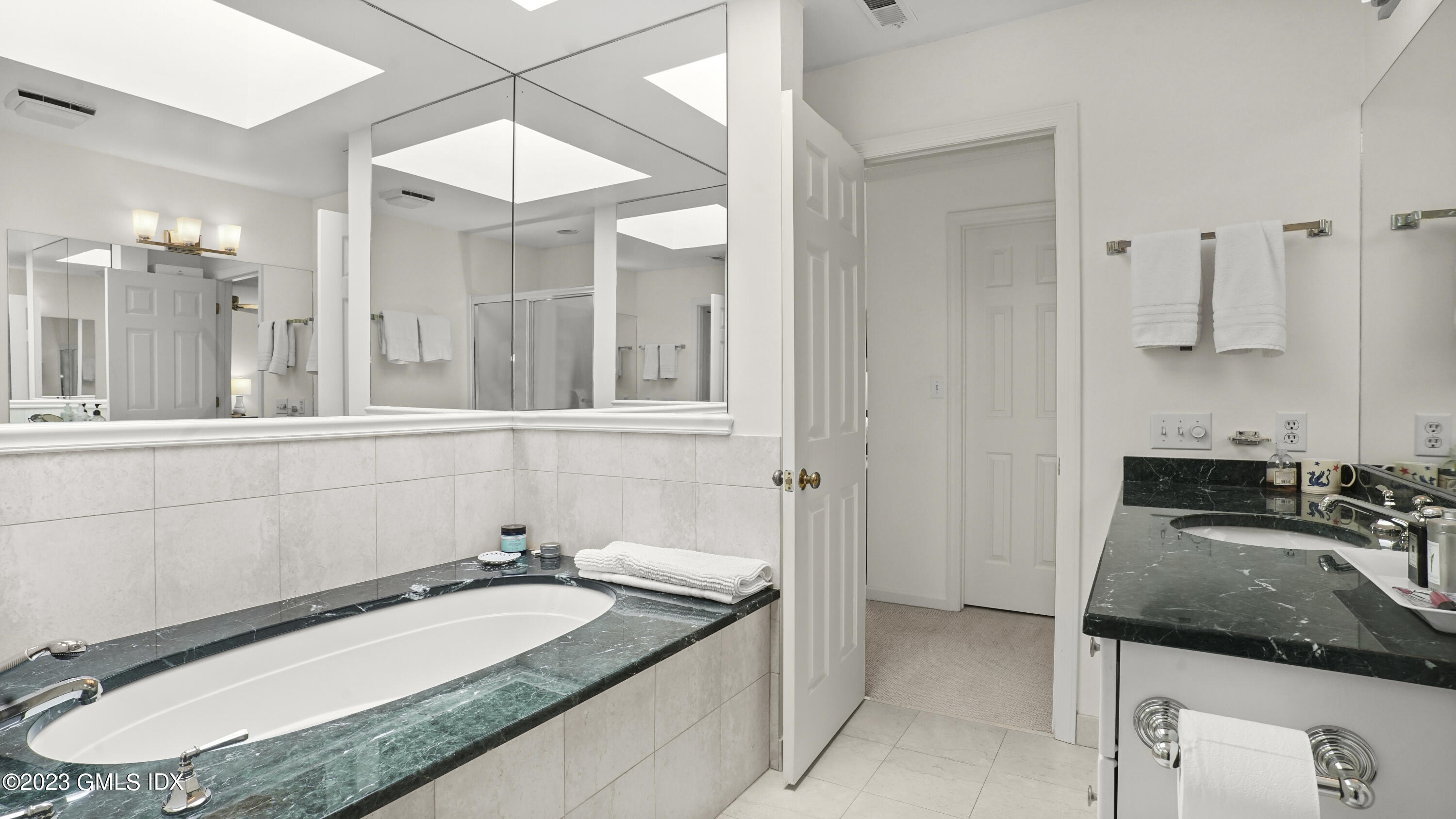 172 Field Point Road, Unit 2 Greenwich, CT 06830 - Photo 10 of 17 a bathroom with a granite countertop sink and a mirror