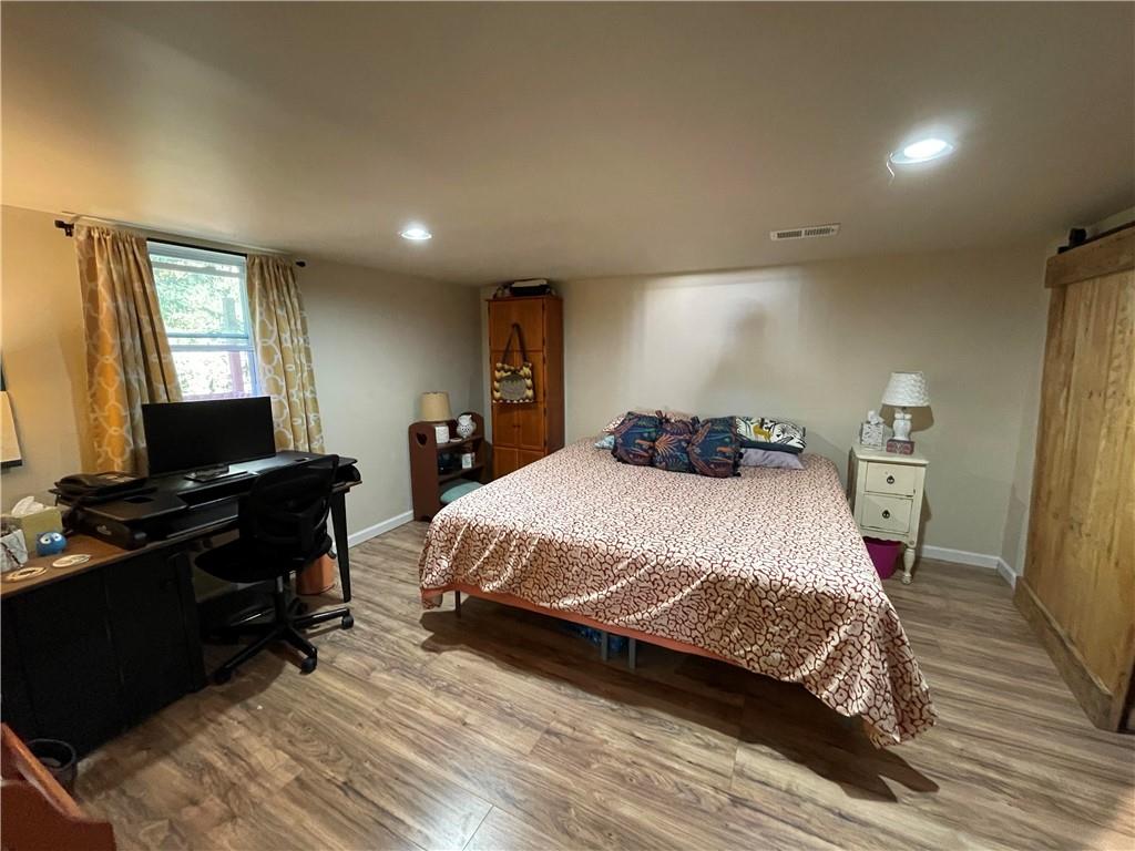 531 Harmony Road Baden, PA 15005 - Photo 17 of 21 Master bedroom on lower level. You can see one of the barn doors to the cupboard on the right.
