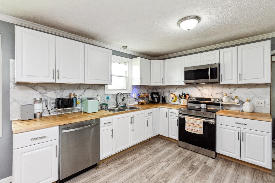 330 Union Camp Road Lafayette, TN 37083 - Photo 11 of 25 a kitchen with cabinets stainless steel appliances a sink and a window