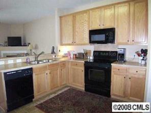 1135 Market Street, Unit 1135 Fort Mill, SC 29708 - Photo 3 of 8 a kitchen with a sink stove and microwave