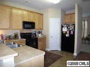 1135 Market Street, Unit 1135 Fort Mill, SC 29708 - Photo 4 of 8 a kitchen with a refrigerator stove and sink