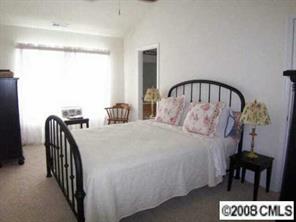 1135 Market Street, Unit 1135 Fort Mill, SC 29708 - Photo 6 of 8 a bedroom with a bed and a table