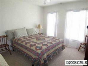 1135 Market Street, Unit 1135 Fort Mill, SC 29708 - Photo 7 of 8 a bed sitting in a bedroom next to a window