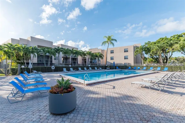 a view of a patio with chairs and plants