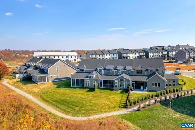 a aerial view of a house with a big yard and large trees