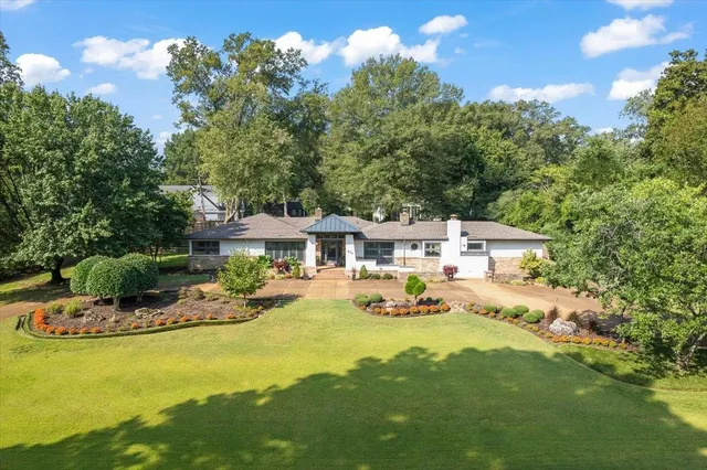 a aerial view of a house with swimming pool garden and patio