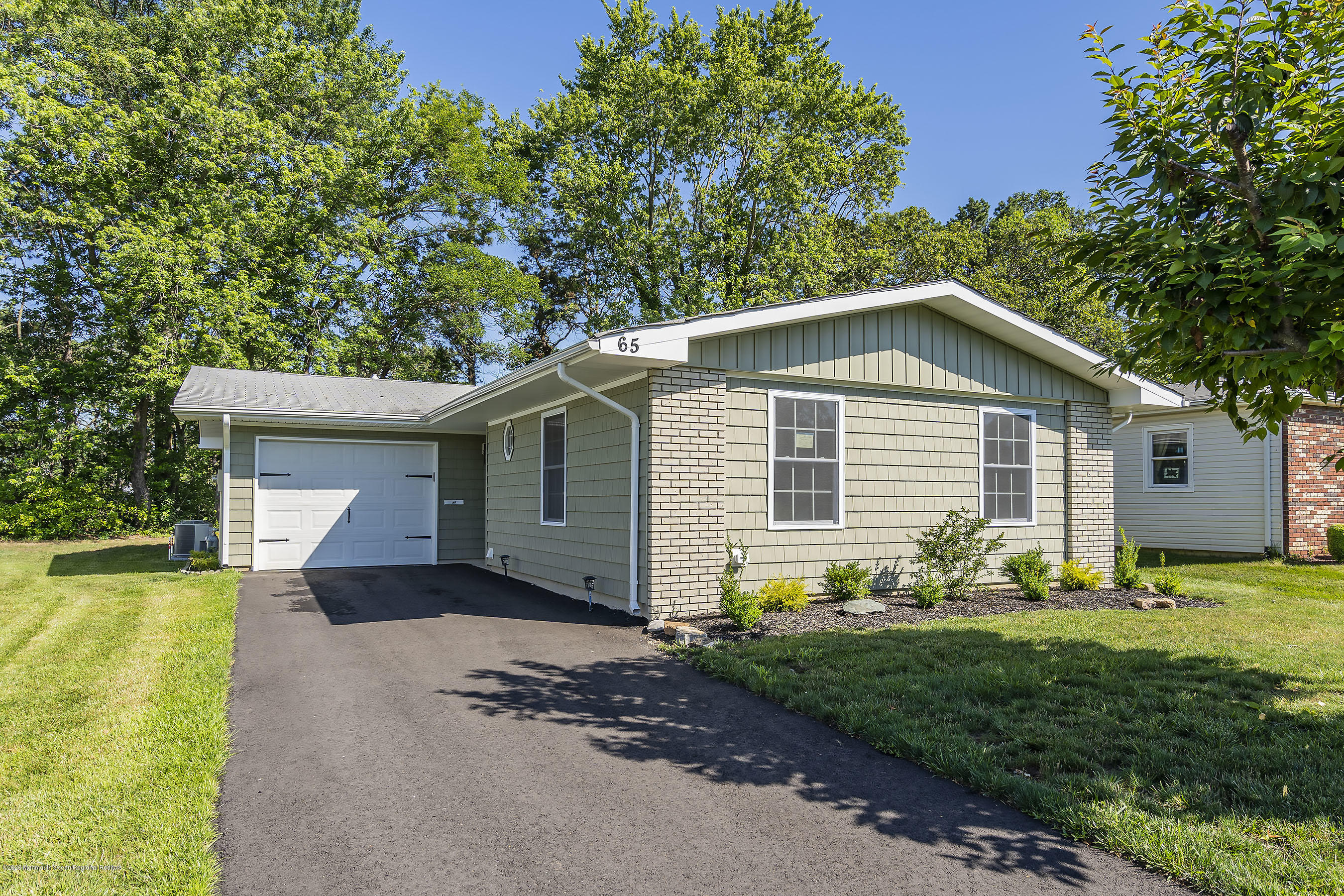 65 Markham Road Brick, NJ 08724 - Photo 1 of 27 a front view of house with yard and green space
