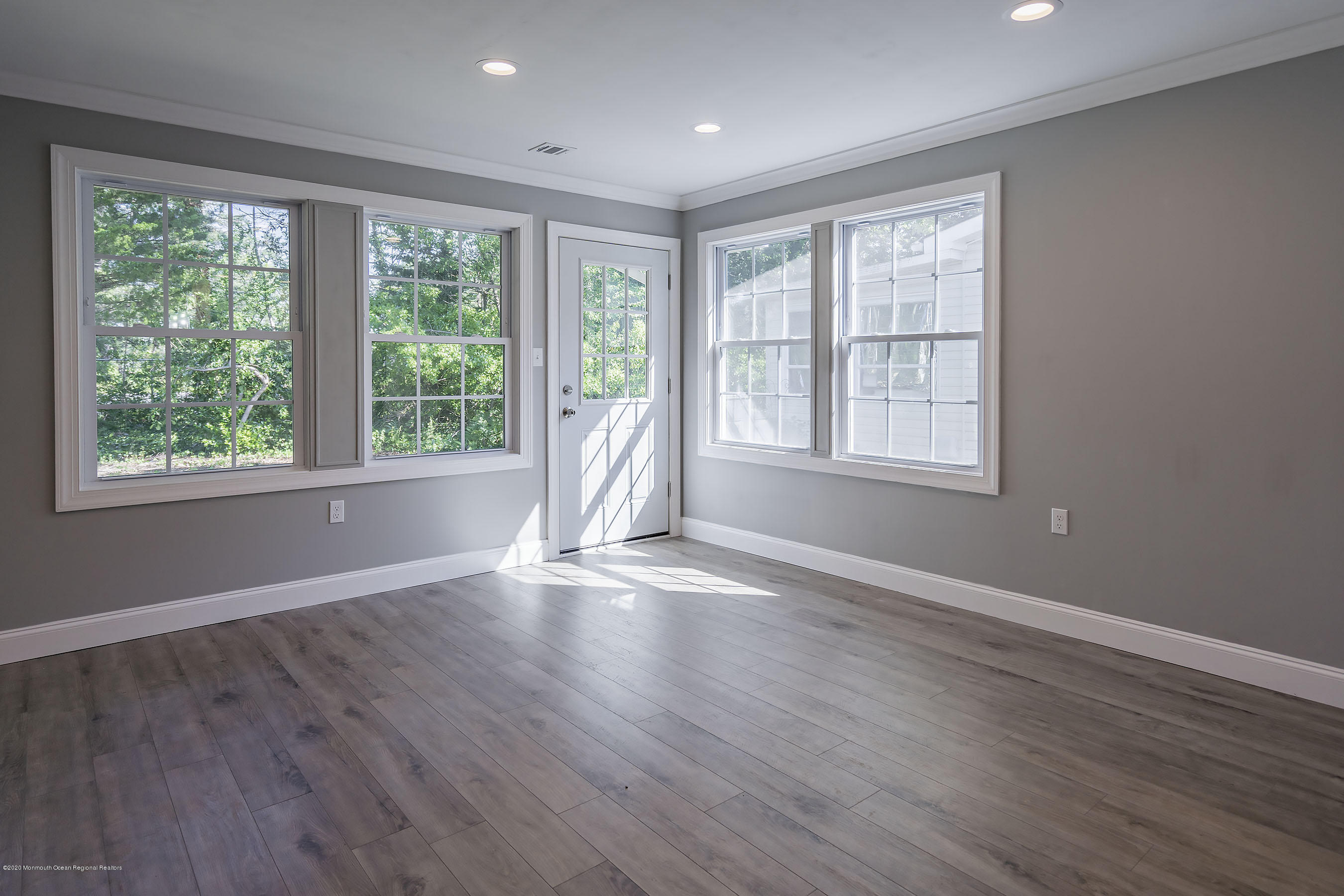 65 Markham Road Brick, NJ 08724 - Photo 14 of 27 an empty room with wooden floor and windows