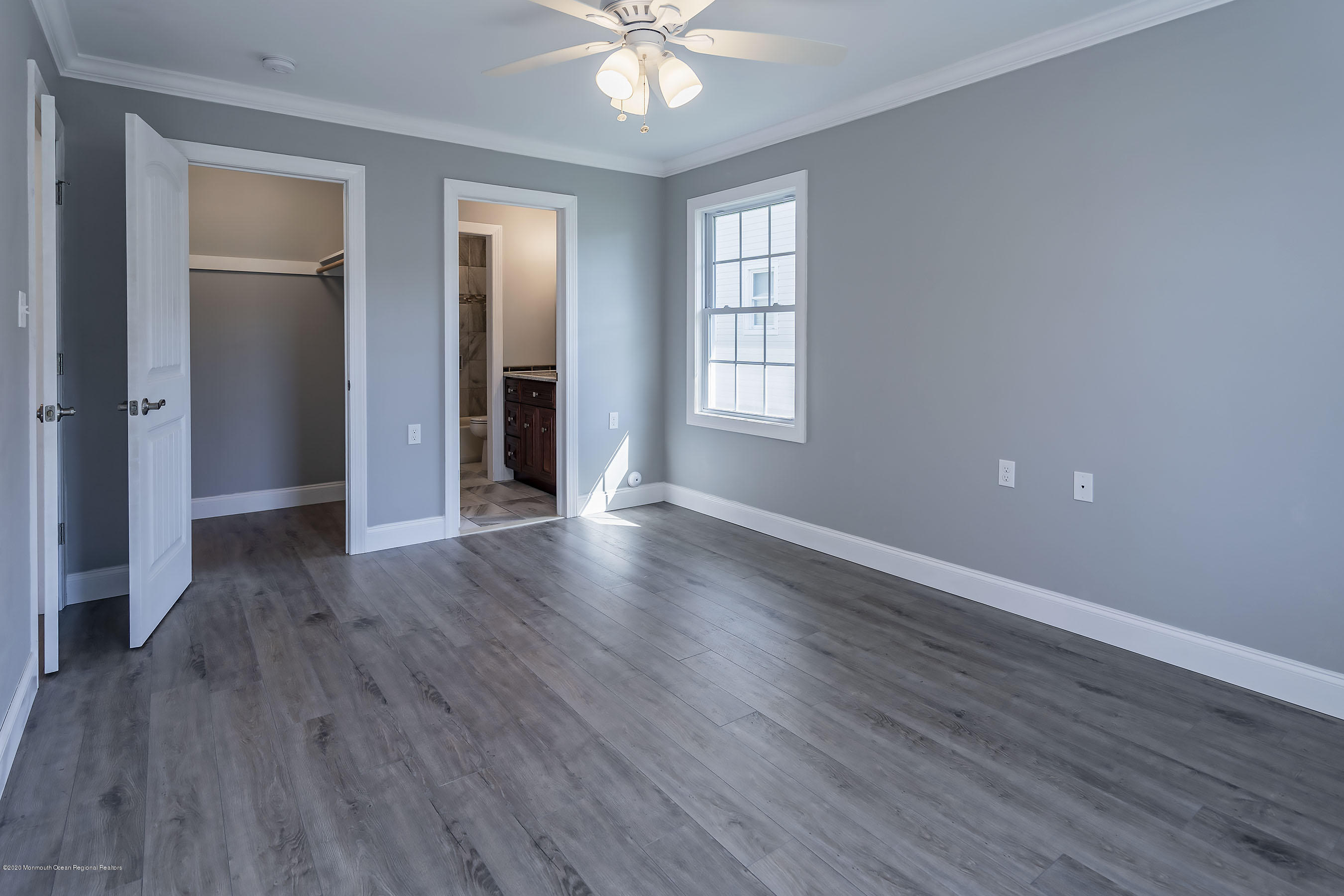 65 Markham Road Brick, NJ 08724 - Photo 19 of 27 an empty room with wooden floor and windows
