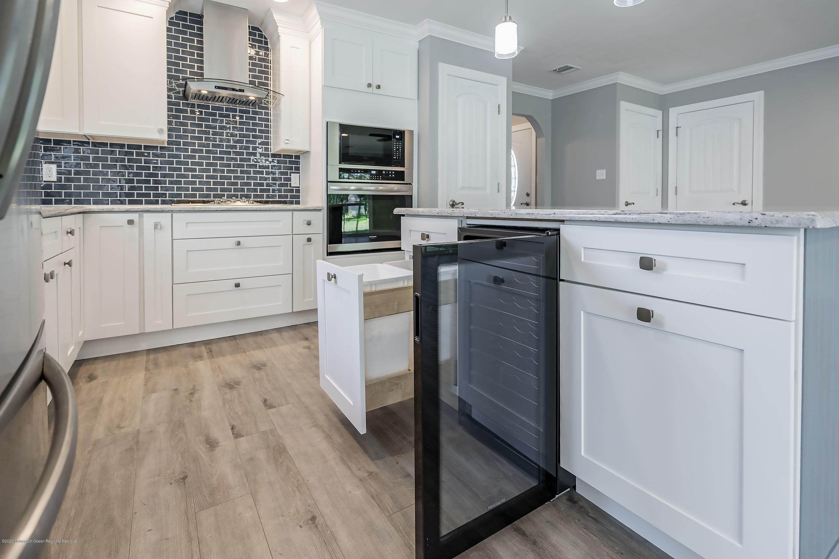 65 Markham Road Brick, NJ 08724 - Photo 6 of 27 a kitchen with granite countertop white cabinets and stainless steel appliances