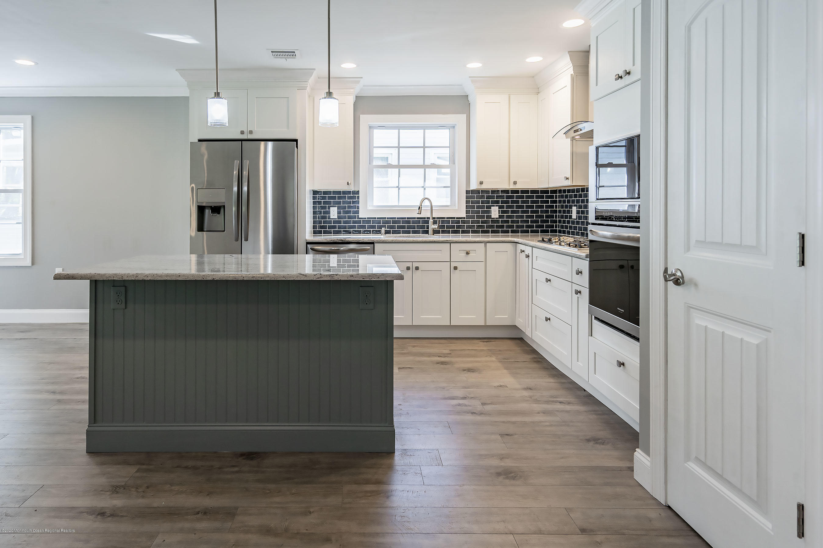 65 Markham Road Brick, NJ 08724 - Photo 8 of 27 a kitchen with stainless steel appliances granite countertop a refrigerator a sink dishwasher a stove and white countertops with wooden floor