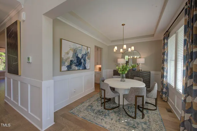 a view of a dining room with furniture and a chandelier