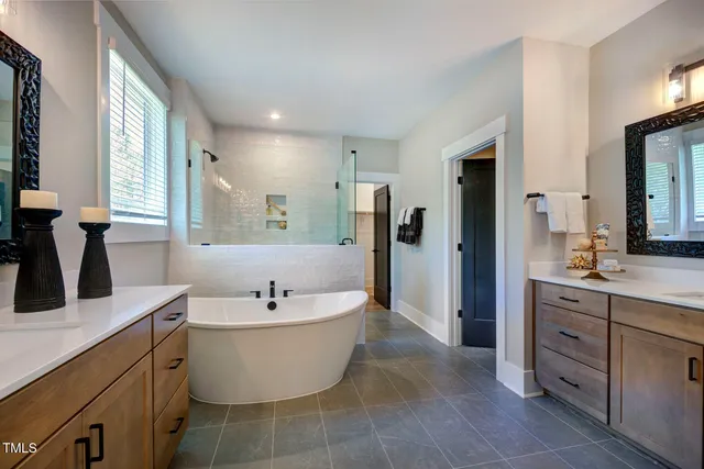a bathroom with a bathtub sink and mirror