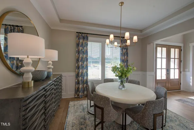 a living room with furniture a dining table and kitchen view