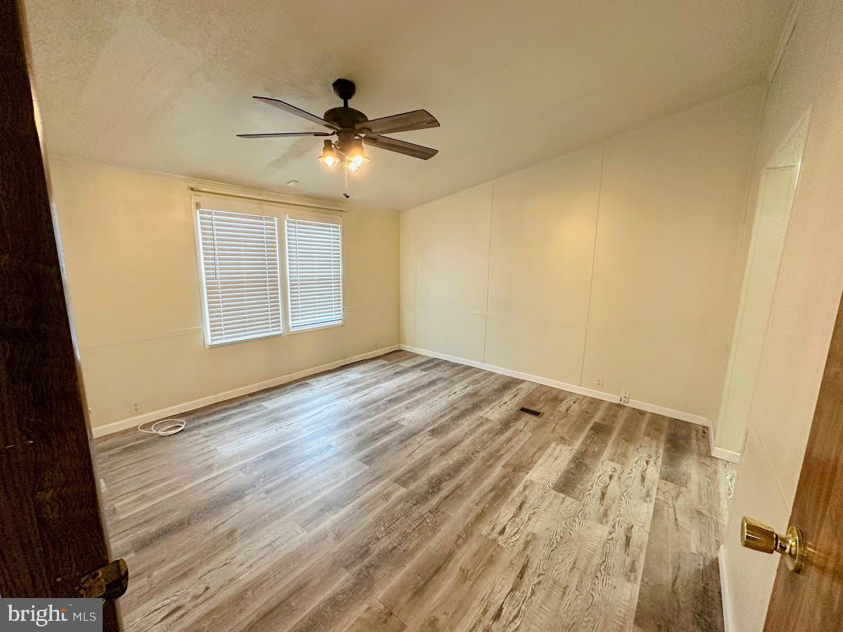 19 Gordon Drive Dover, DE 19901 - Photo 11 of 19 a view of empty room with wooden floor and fan